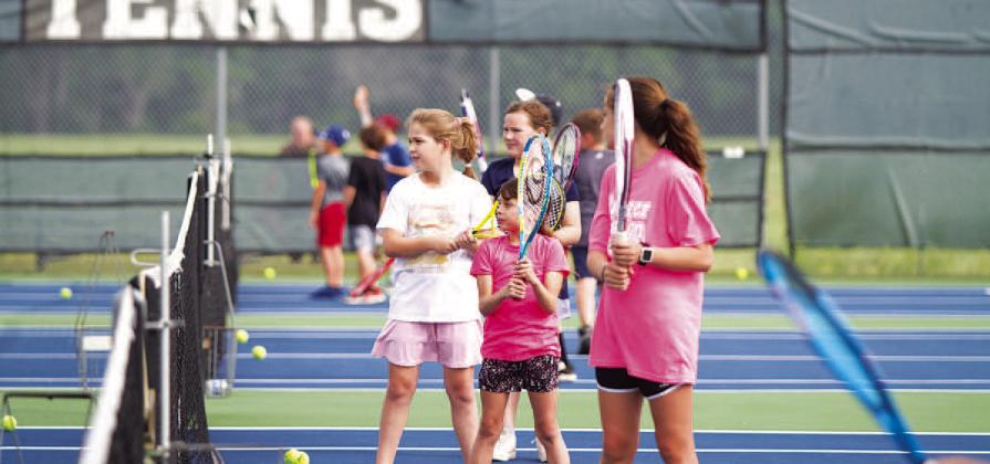 HUNTER KING | DISPATCH RECORD A group of young tennis players work on their volleys at camp on Tuesday.