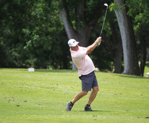 Scott Haverly hits a shot from the fairway on hole fiveduring last year’s A.C. January Memorial Golf Tournament. FILE PHOTO